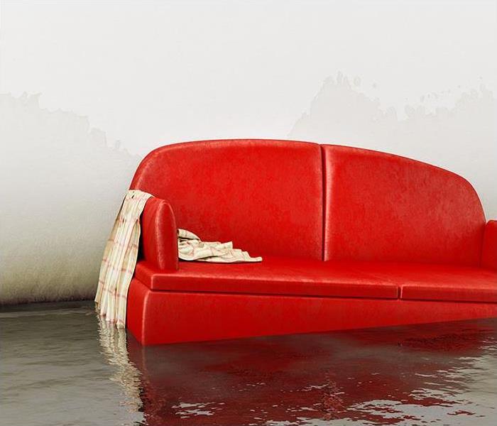 Living room with red couch floating in a shallow pool of water