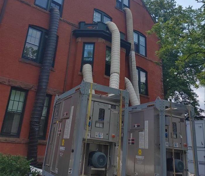 ducts forcing dry air into three story brick building