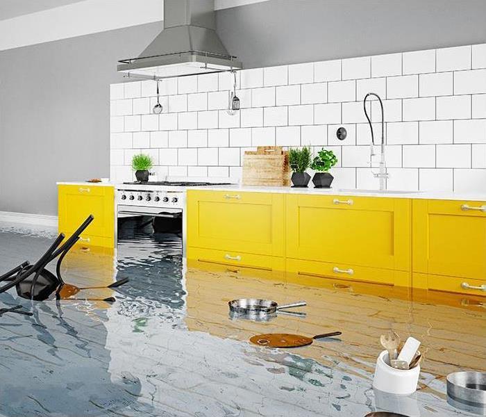 kitchen with yellow cabinets and water pooled on the floor and floating pans